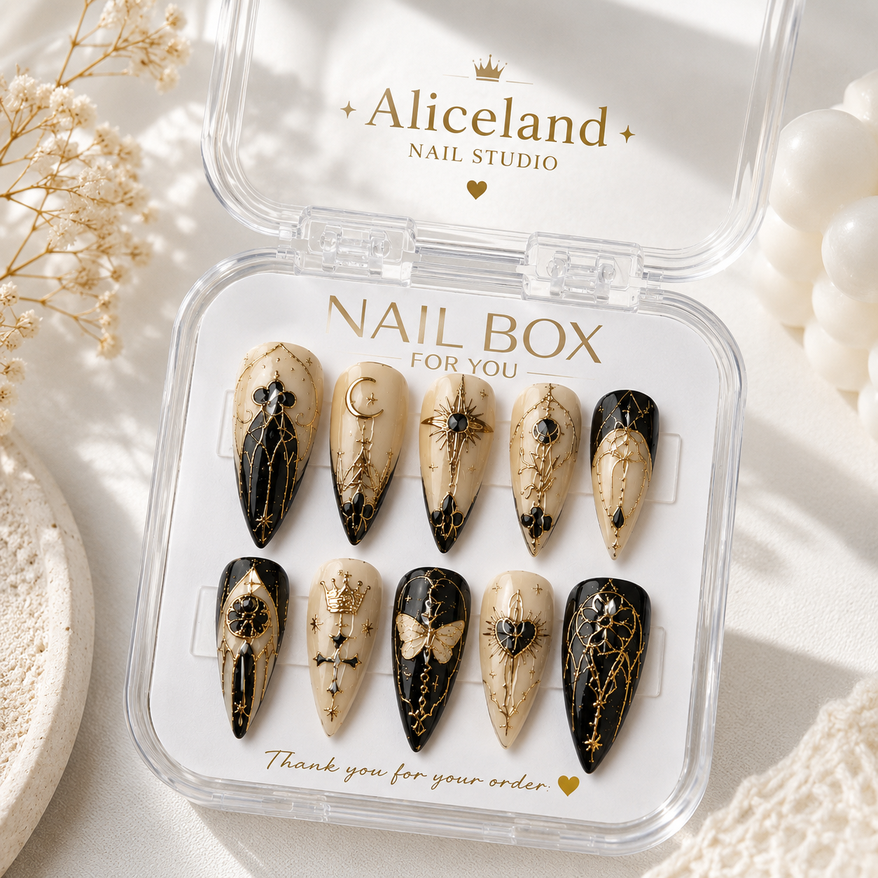 Celestial Noir stiletto press on nails with moon, stars and gothic gold artwork