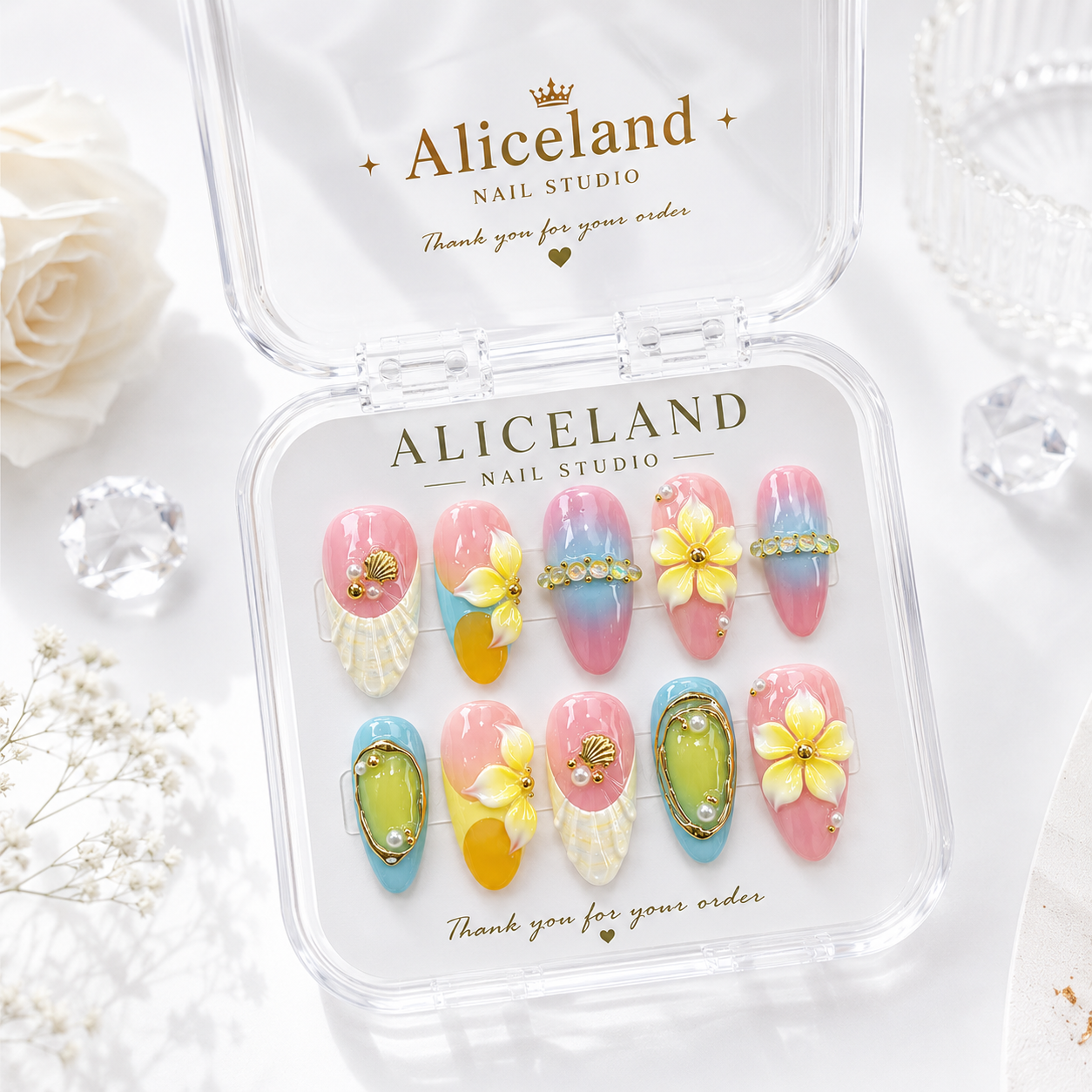 Island Bloom almond press on nails featuring tropical flowers, seashell details and luxury summer nail art