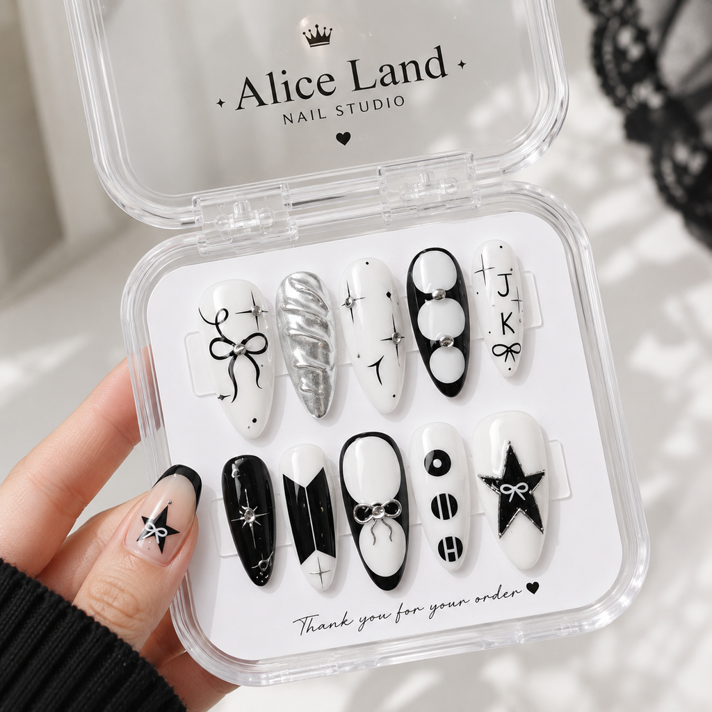Midnight Coquette almond press on nails with black and white bow design and rhinestone accents