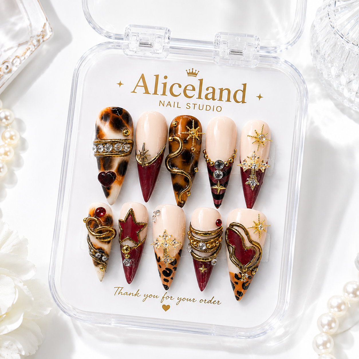 Mocha Luxe stiletto press on nails featuring gold chrome details, mocha marble and elegant neutral nail art