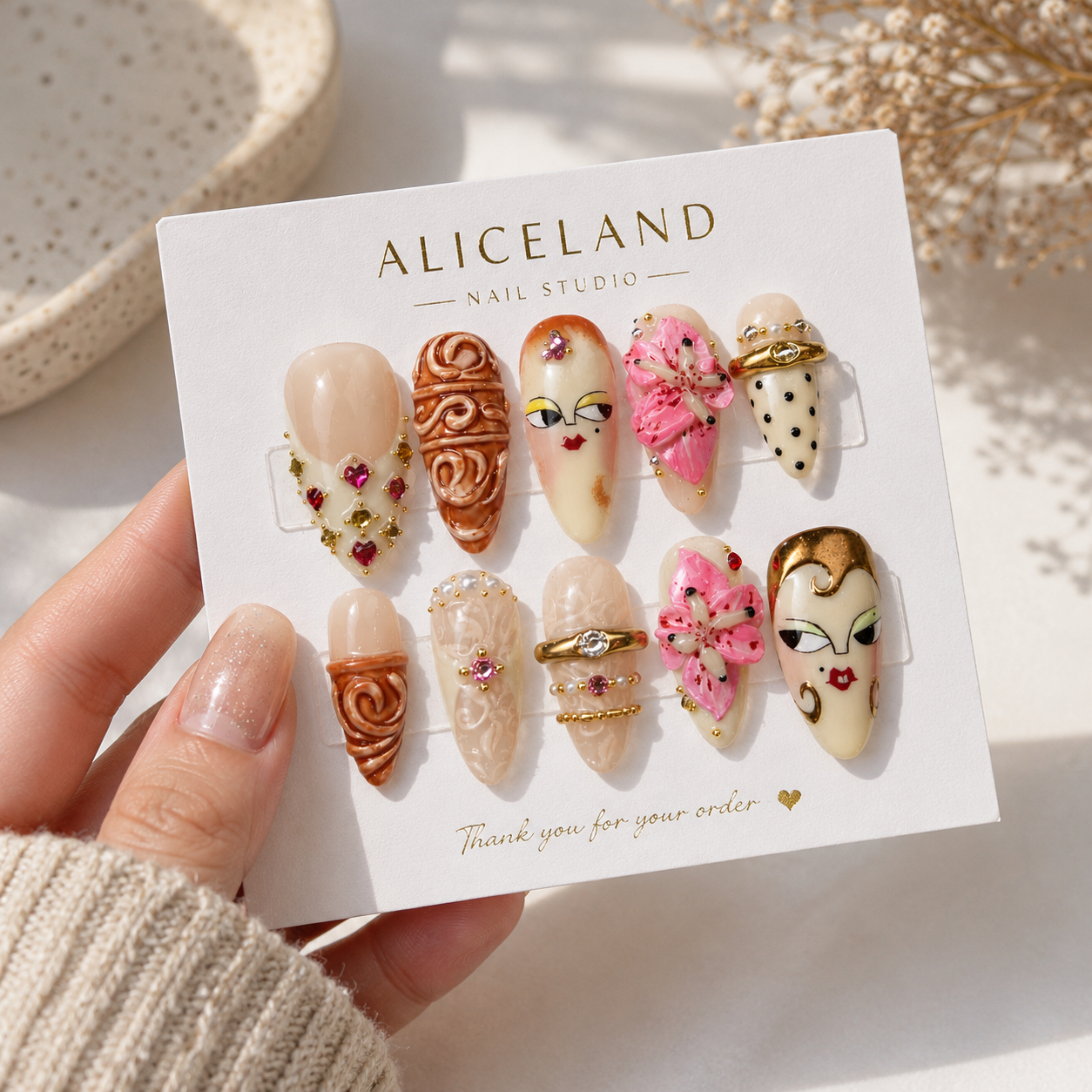Muse Bloom almond press on nails with abstract face art and 3D lily flower design