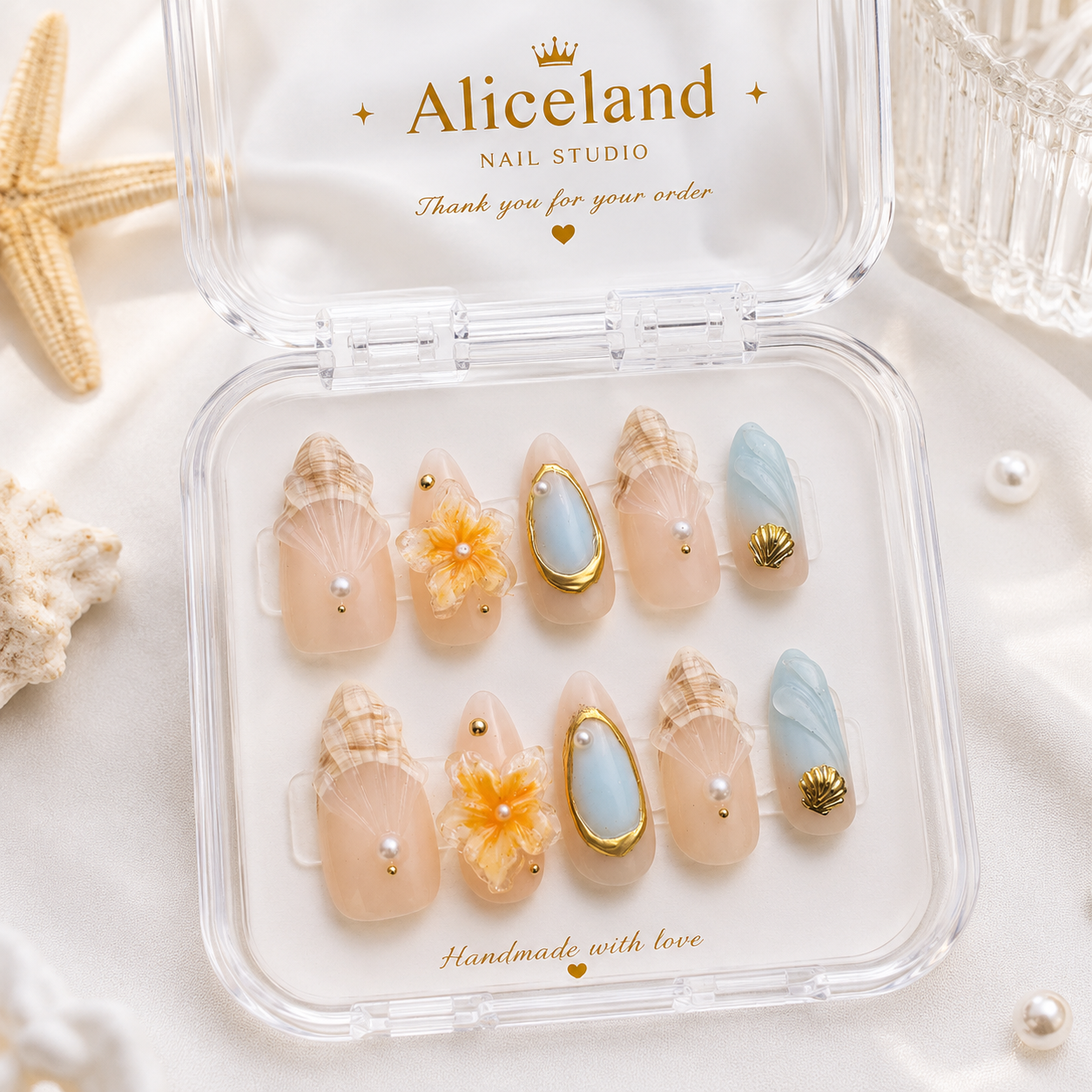 Seashell Blossom almond press on nails featuring 3D flowers, seashell accents, pearls and coastal luxury nail art